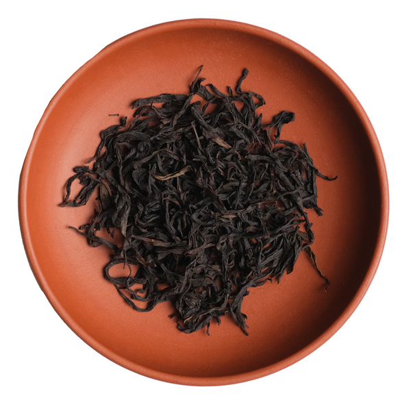 Dried black tea leaves on a terracotta plate